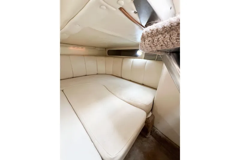 Slide: The Image of Interior cabin of 2000 Rinker Fiesta Vee 330 with white cushioned seating. - 35