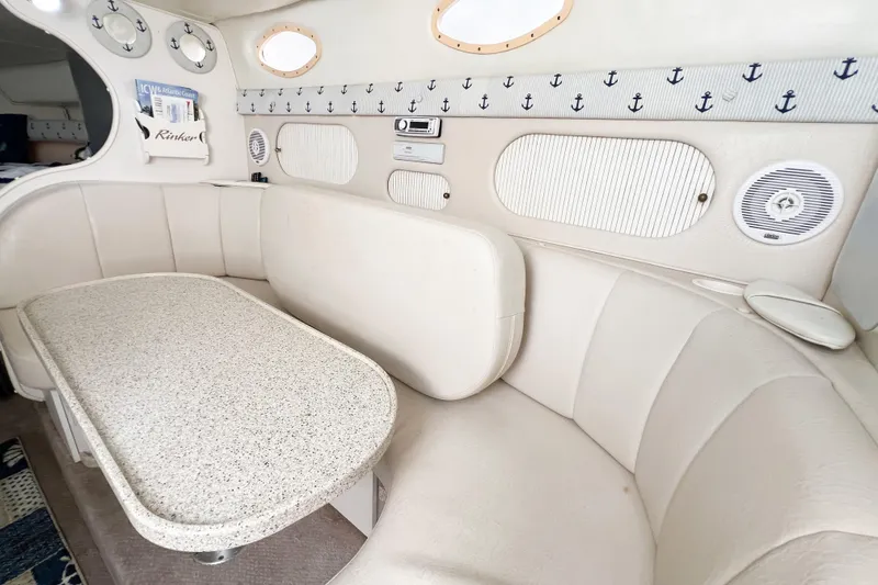 Slide: The Image of Interior of 2000 Rinker Fiesta Vee 330 boat with white seating and nautical decor. - 36