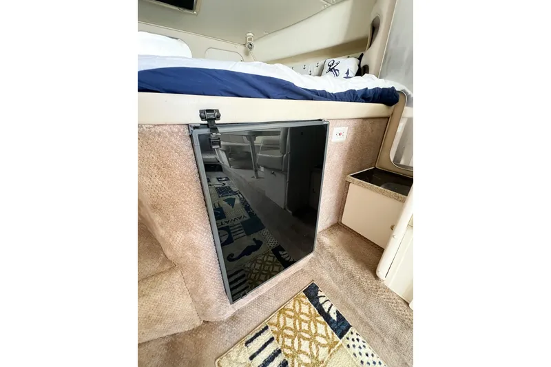 Slide: The Image of Interior of 2000 Rinker Fiesta Vee 330 boat with bed and carpeted flooring. - 37