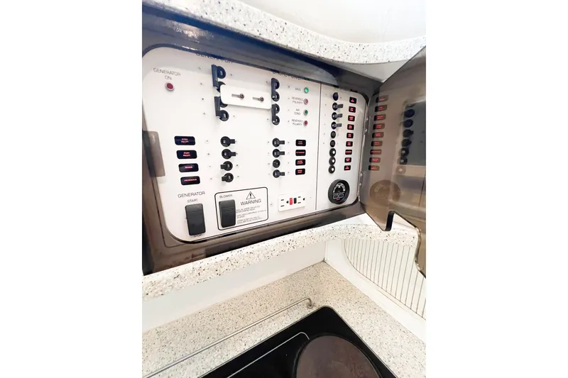 Slide: The Image of Control panel of a 2000 Rinker Fiesta Vee 330 boat, featuring switches and indicators. - 49