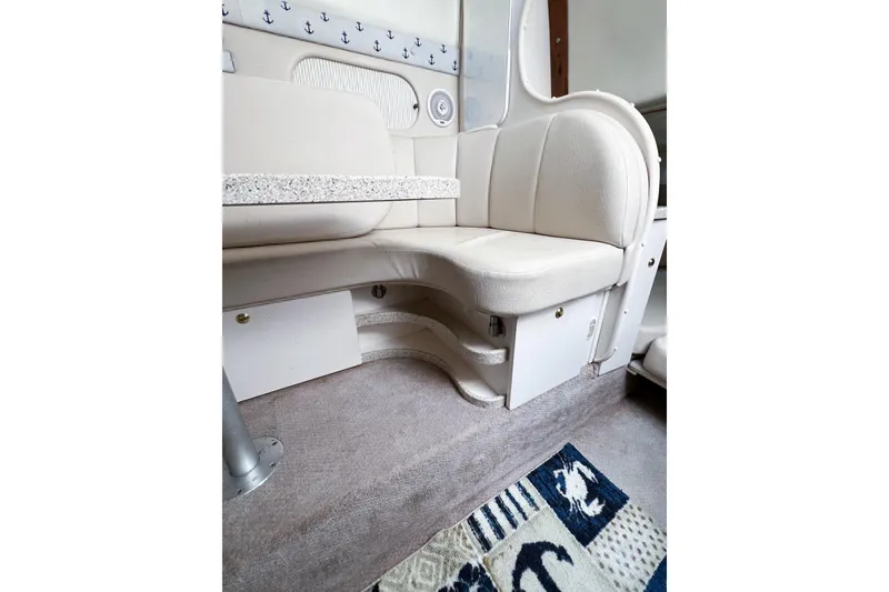 Slide: The Image of Interior of 2000 Rinker Fiesta Vee 330 boat with beige seating and nautical decor. - 50