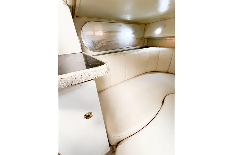 Slide: The Image of Interior of 2000 Rinker Fiesta Vee 330 boat with cream seating and countertop. - 51