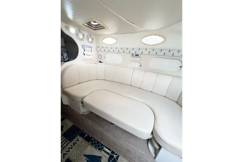 Slide: The Image of Interior of 2000 Rinker Fiesta Vee 330 boat with white leather seating and nautical decor. - 52