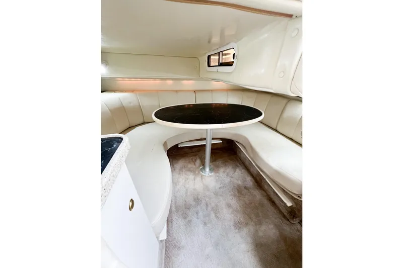 Slide: The Image of Interior of 2000 Rinker Fiesta Vee 330 boat with curved seating and table. - 53