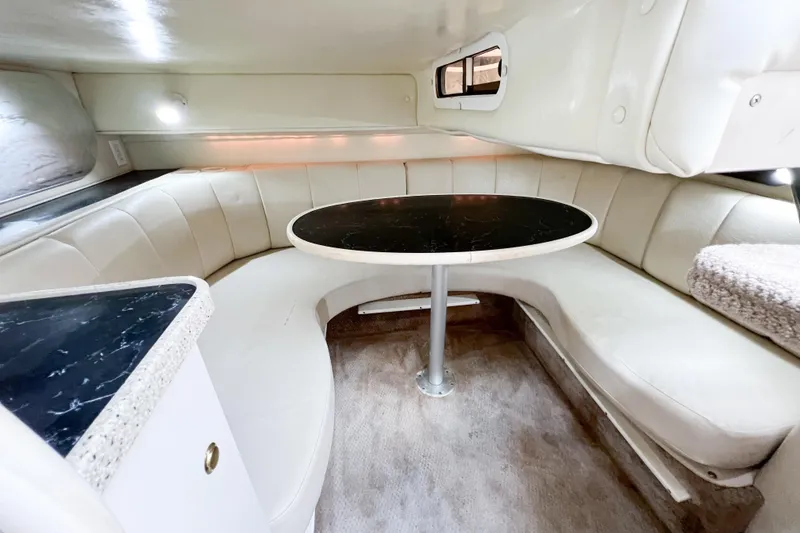 Slide: The Image of Interior of 2000 Rinker Fiesta Vee 330 boat with curved seating and table. - 54