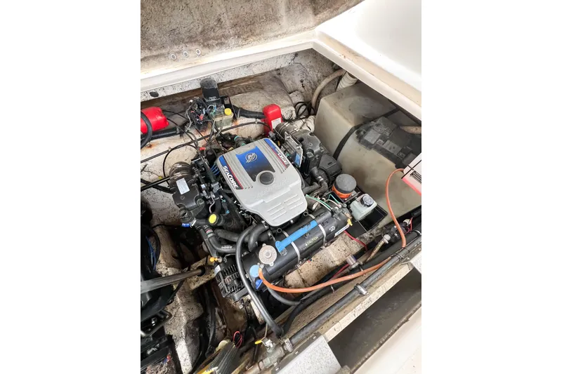 Slide: The Image of Engine compartment of a 2000 Rinker Fiesta Vee 330 boat, showcasing detailed components. - 55