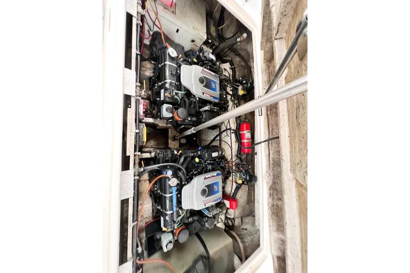 Slide: The Image of Engine compartment of a 2000 Rinker Fiesta Vee 330 boat, featuring dual engines. - 56