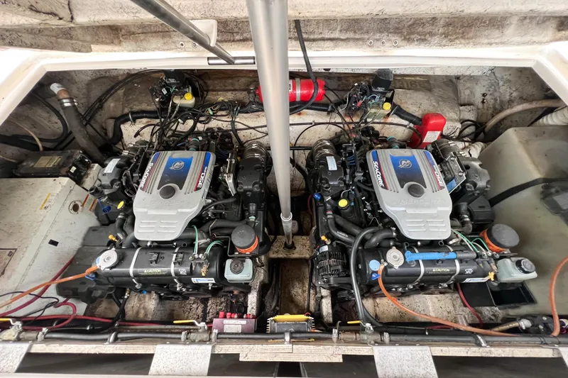 Slide: The Image of Engine compartment of a 2000 Rinker Fiesta Vee 330 boat, featuring dual MerCruiser engines. - 57