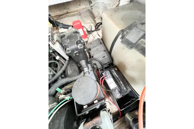 Slide: The Image of Engine compartment of a 2000 Rinker Fiesta Vee 330 boat, showing battery and wiring. - 58