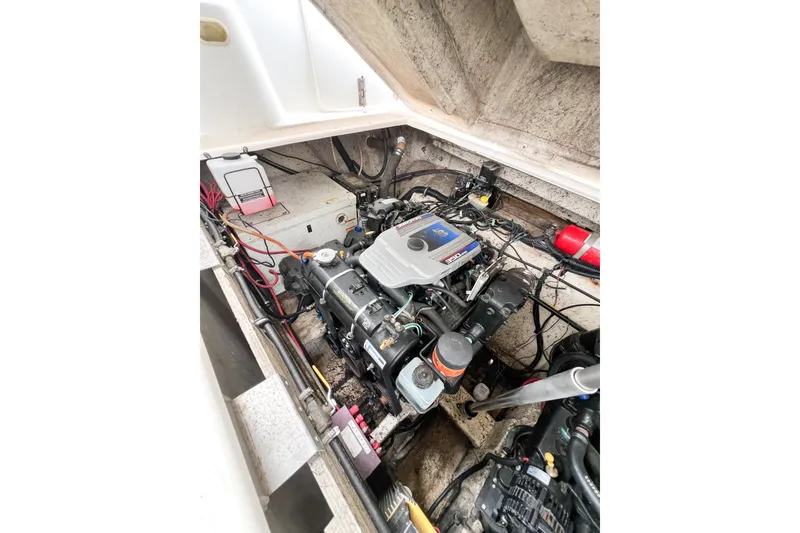 Slide: The Image of Engine compartment of a 2000 Rinker Fiesta Vee 330 boat, showcasing mechanical components. - 59