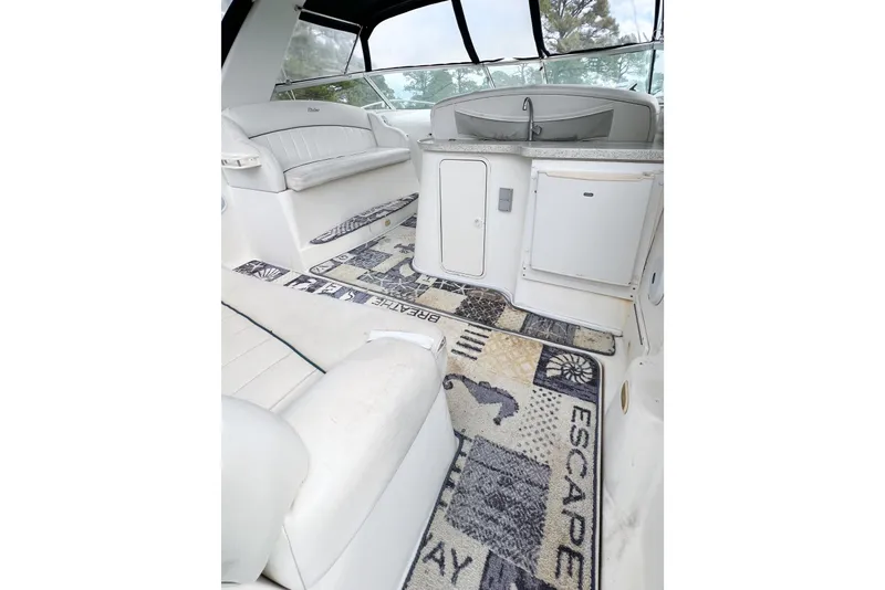 Slide: The Image of Interior of 2000 Rinker Fiesta Vee 330 boat with white seating and patterned carpet. - 6