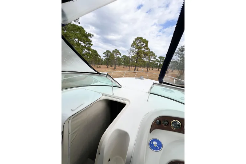 Slide: The Image of 2000 Rinker Fiesta Vee 330 boat interior with forest view through windshield. - 61