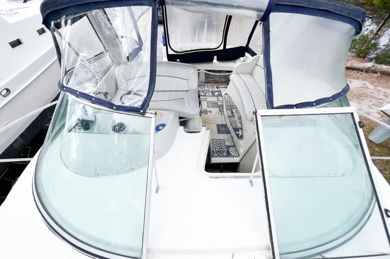 Slide: The Image of 2000 Rinker Fiesta Vee 330 boat interior with seating and clear canopy. - 64
