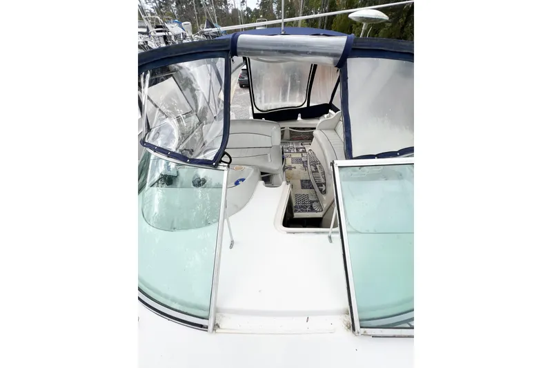 Slide: The Image of 2000 Rinker Fiesta Vee 330 boat interior with seating and clear canopy. - 65