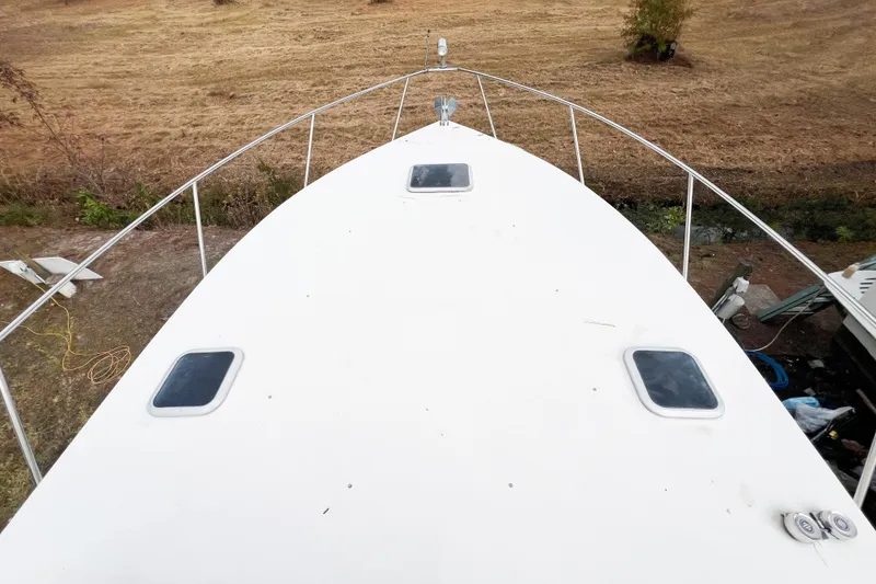 Slide: The Image of Top view of a 2000 Rinker Fiesta Vee 330 boat deck, showing hatches and railing. - 66