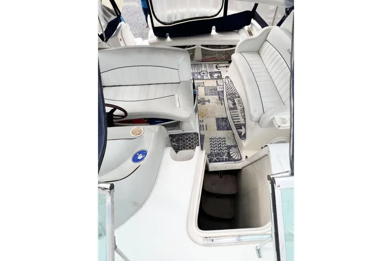Slide: The Image of Interior of 2000 Rinker Fiesta Vee 330 boat with white seating and patterned flooring. - 67