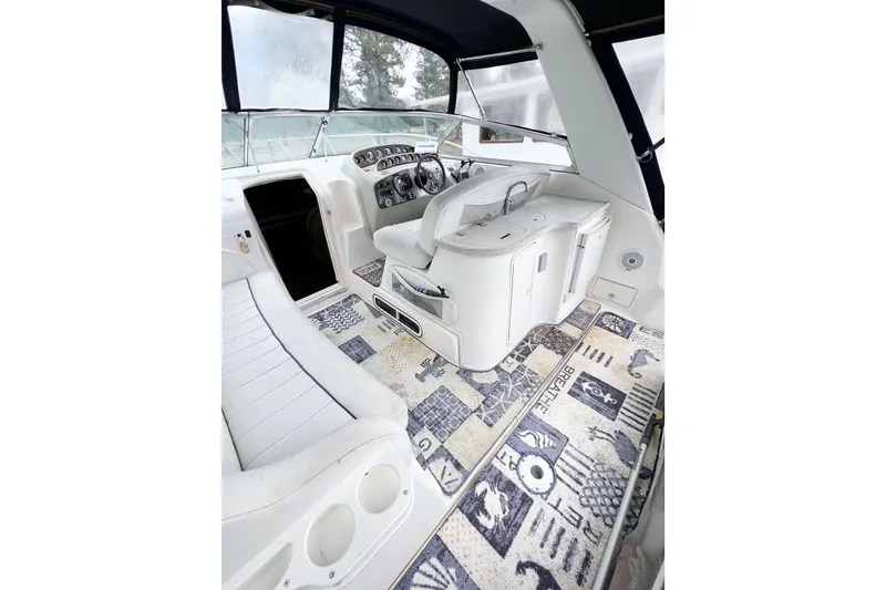Slide: The Image of Interior of 2000 Rinker Fiesta Vee 330 boat with white seating and patterned carpet. - 7