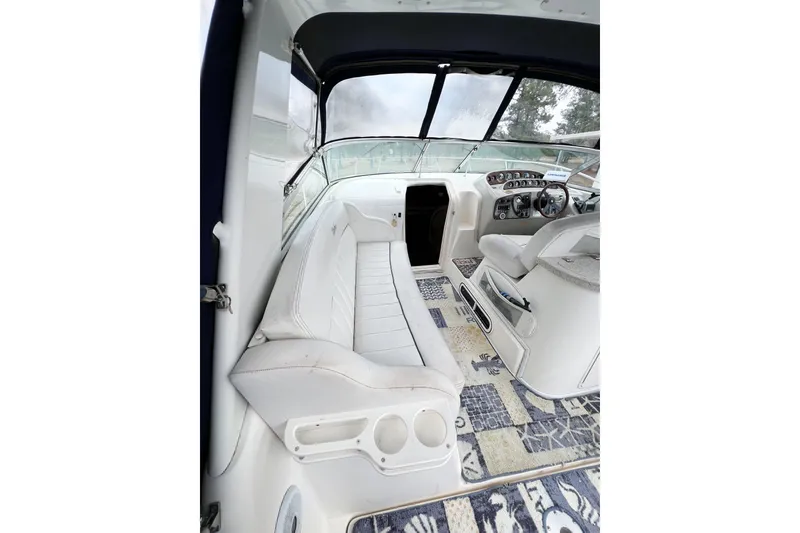 Slide: The Image of Interior of 2000 Rinker Fiesta Vee 330 boat with white seating and patterned flooring. - 9