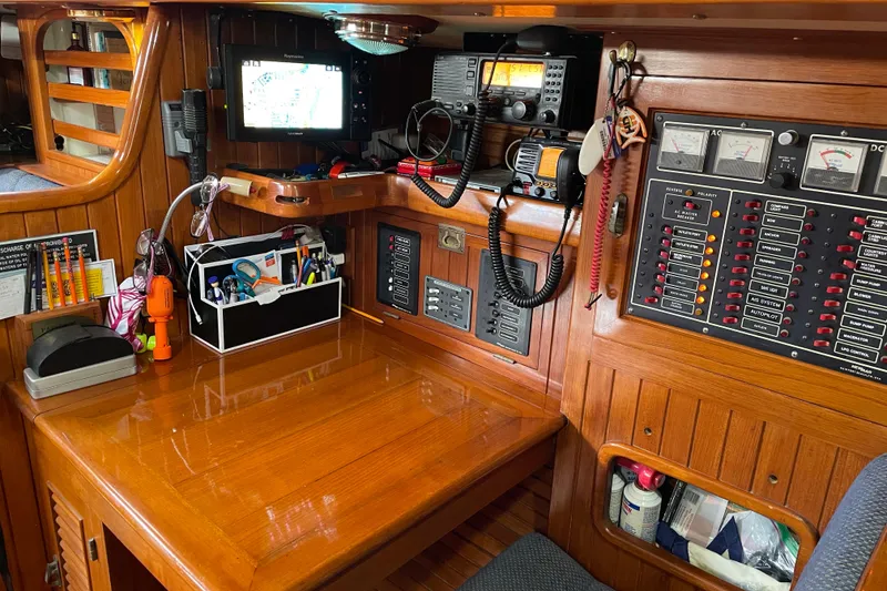 Slide: The Image of Cozy interior of 1985 Passport 470 Center Cockpit with wooden table and seating area. - 11