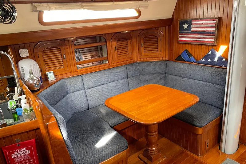 Slide: The Image of Cozy interior of 1985 Passport 470 Center Cockpit sailboat with wood paneling and nautical decor. - 12