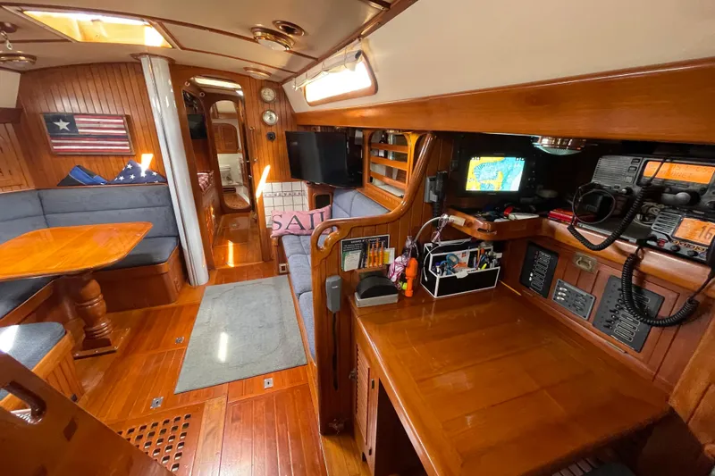 Slide: The Image of Interior of 1985 Passport 470 Center Cockpit yacht with wooden furnishings and navigation equipment. - 14