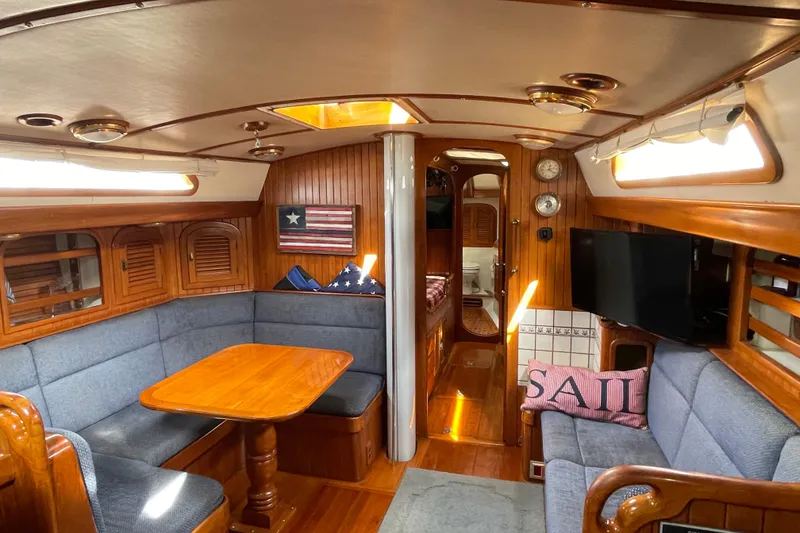 Slide: The Image of Interior of 1985 Passport 470 Center Cockpit yacht with cozy seating and nautical decor. - 15