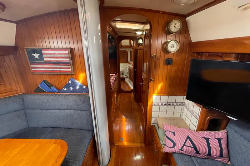 Slide: The Image of Interior of 1985 Passport 470 Center Cockpit yacht with cozy seating and nautical decor. - 17
