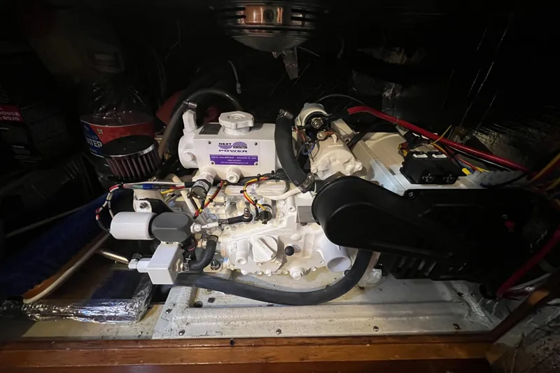 Slide: The Image of Engine compartment of a 1985 Passport 470 Center Cockpit sailboat, showcasing mechanical components. - 25
