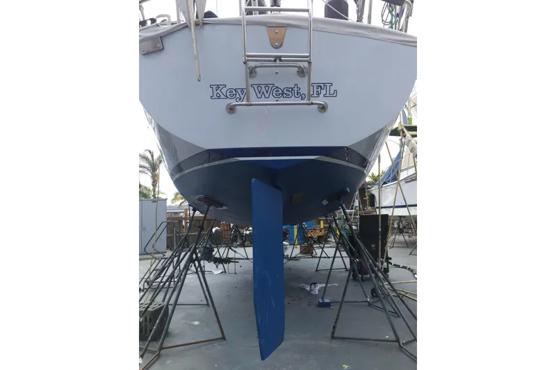 Slide: The Image of 1985 Passport 470 Center Cockpit sailboat on dry dock, undergoing maintenance. - 3