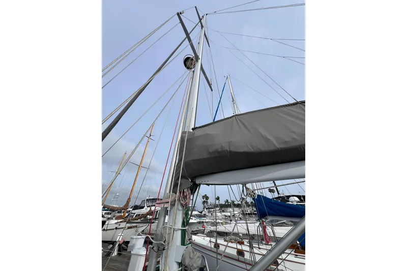 Slide: The Image of Sailboat mast and rigging of 1985 Passport 470 Center Cockpit at marina. - 32