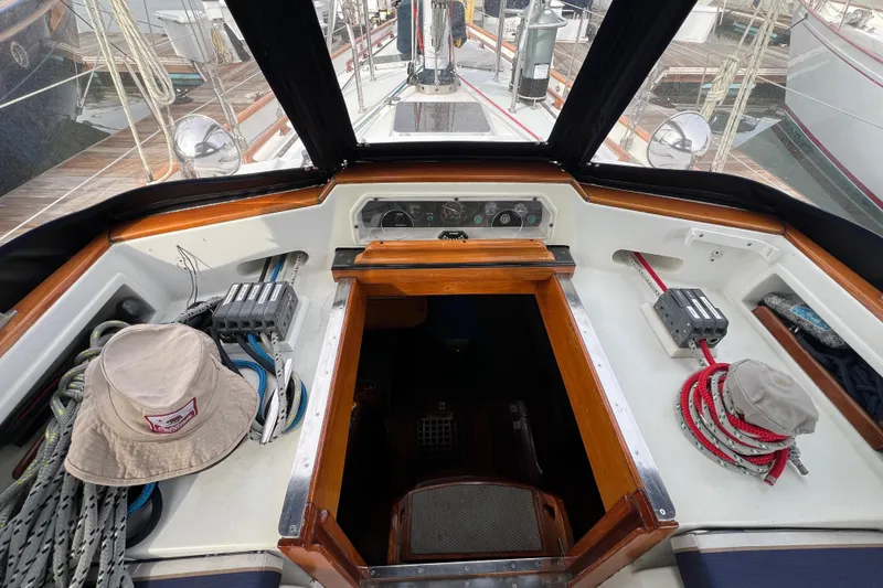 Slide: The Image of Cockpit of 1985 Passport 470 Center Cockpit sailboat with ropes and navigation equipment. - 38