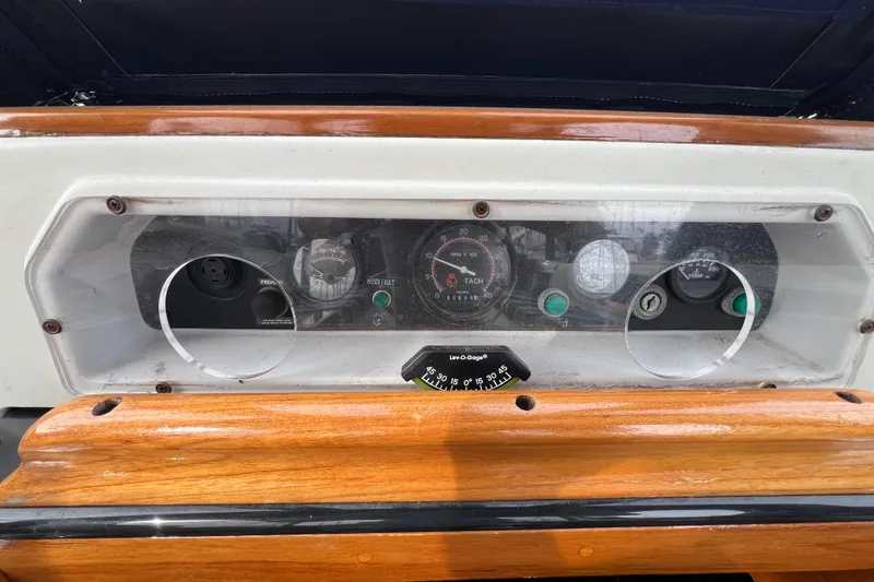 Slide: The Image of Dashboard of a 1985 Passport 470 Center Cockpit sailboat with gauges and controls. - 39