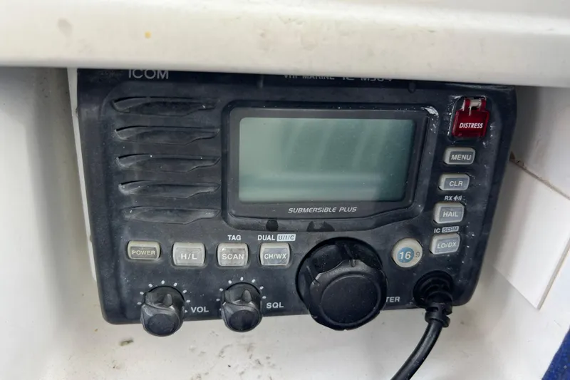Slide: The Image of ICOM marine radio on 1985 Passport 470 Center Cockpit, featuring distress button and controls. - 42