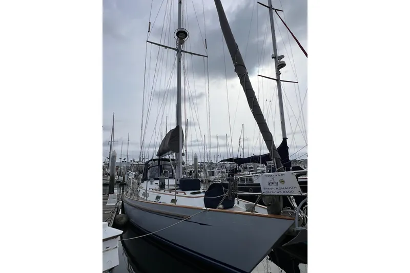 Slide: The Image of Sailboat docked at marina, Passport 470 Center Cockpit, 1985 model, overcast sky. - 43