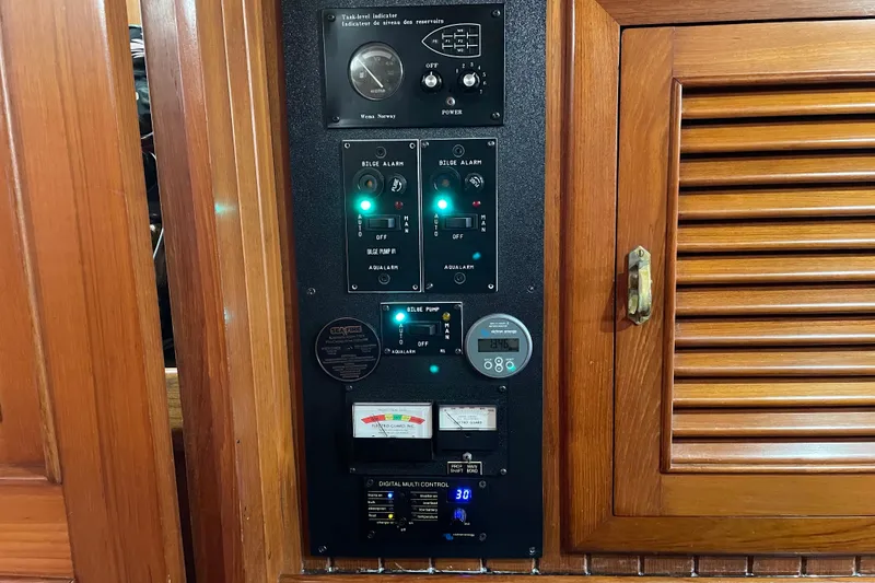 Slide: The Image of 1985 Passport 470 Center Cockpit yacht kitchen with wooden cabinetry and modern appliances. - 7