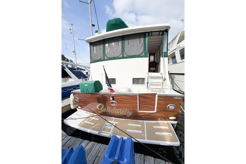 Slide: The Image of 1989 Jefferson Marquessa 52 Extended Deckhouse yacht docked at marina. - 10