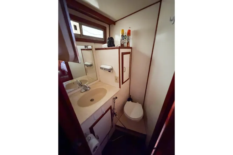 Slide: The Image of Bathroom interior of 1989 Jefferson Marquessa 52 Extended Deckhouse yacht, featuring sink and toilet. - 107
