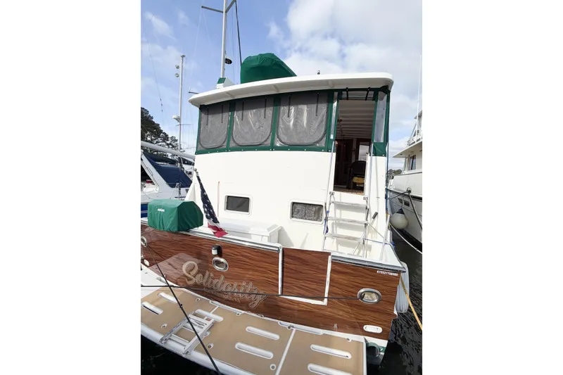 Slide: The Image of 1989 Jefferson Marquessa 52 yacht with extended deckhouse, docked at marina. - 11