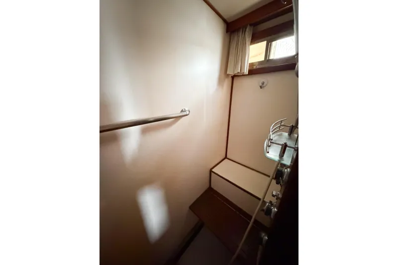 Slide: The Image of Interior of 1989 Jefferson Marquessa 52 yacht, featuring a compact shower area with window. - 110