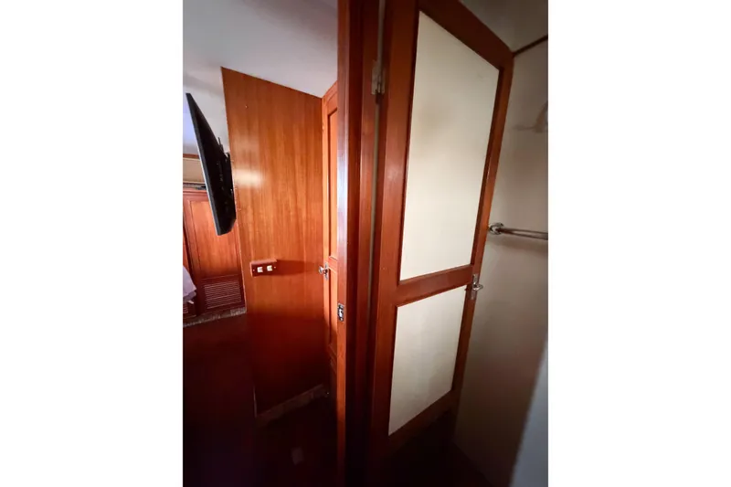 Slide: The Image of Interior view of 1989 Jefferson Marquessa 52 yacht, featuring wooden paneling and a door. - 111