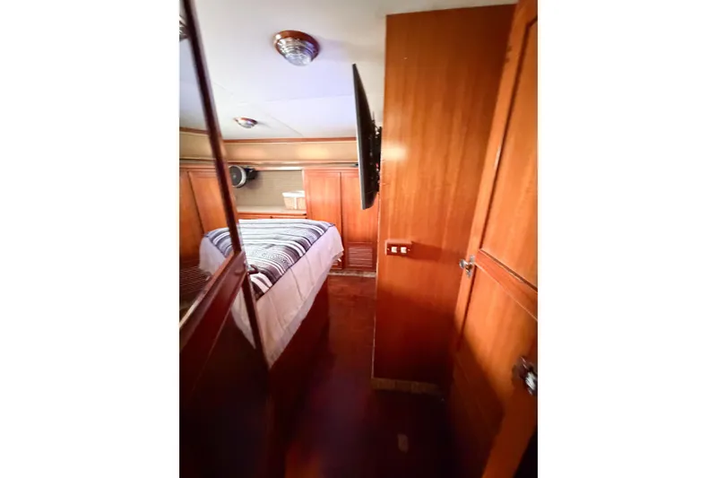Slide: The Image of 1989 Jefferson Marquessa 52 yacht cabin with wood paneling and cozy bed. - 112