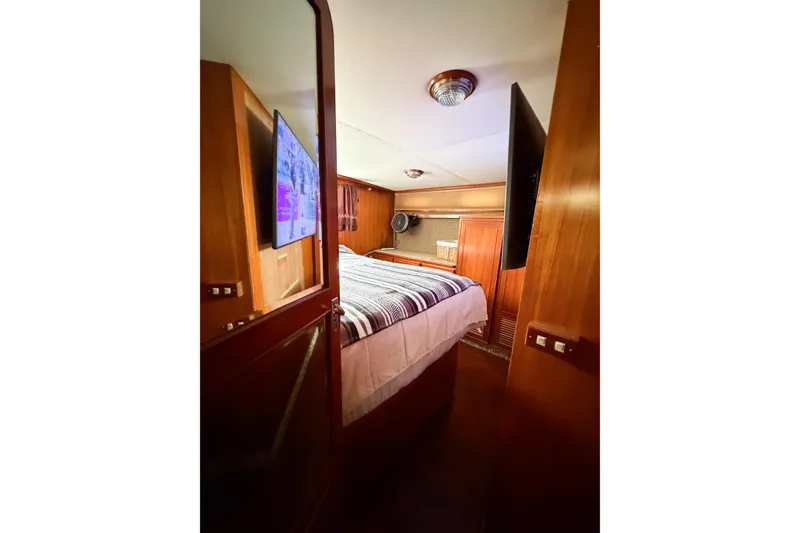 Slide: The Image of Cozy bedroom in 1989 Jefferson Marquessa 52 yacht with wood paneling and TV. - 113