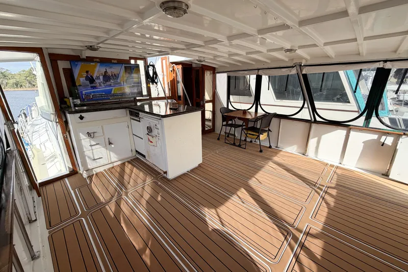 Slide: The Image of Spacious interior of 1989 Jefferson Marquessa 52 yacht with modern amenities and elegant wood flooring. - 115