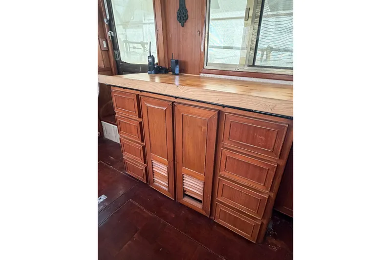 Slide: The Image of Wooden cabinetry inside a 1989 Jefferson Marquessa 52 Extended Deckhouse yacht, featuring a polished countertop. - 124