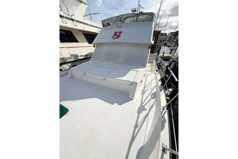 Slide: The Image of 1989 Jefferson Marquessa 52 yacht with extended deckhouse, docked at a marina. - 15