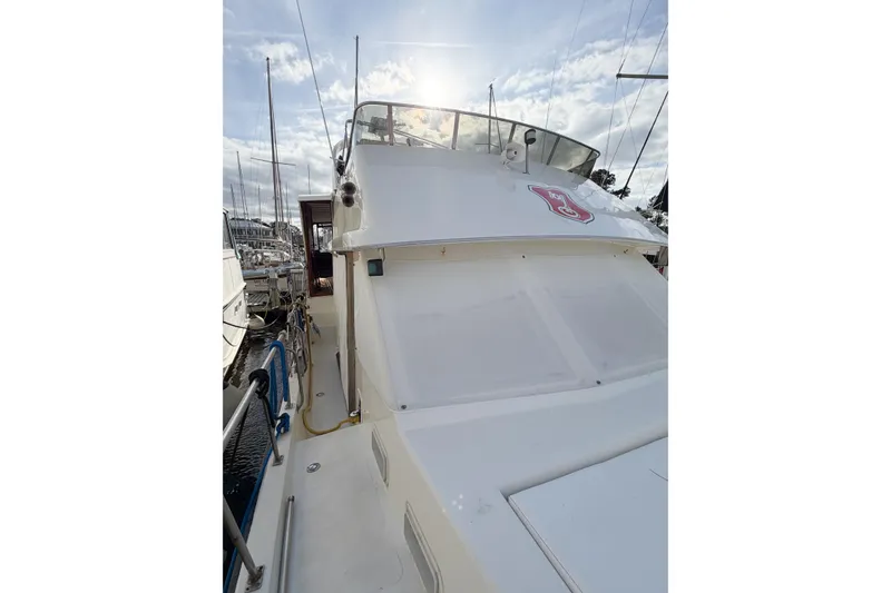 Slide: The Image of 1989 Jefferson Marquessa 52 yacht docked under a bright sky. - 16