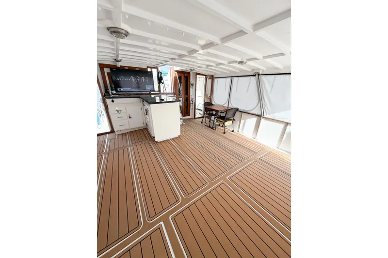 Slide: The Image of Spacious deck of 1989 Jefferson Marquessa 52 Extended Deckhouse with elegant wood flooring. - 18