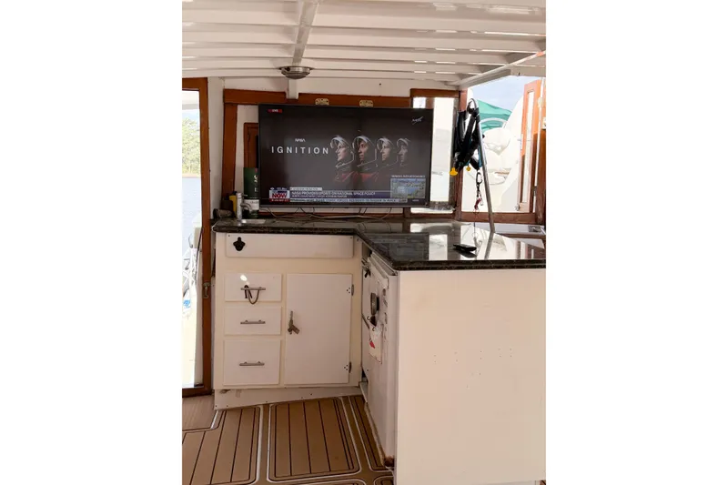 Slide: The Image of 1989 Jefferson Marquessa 52 yacht interior with TV and kitchenette setup. - 19
