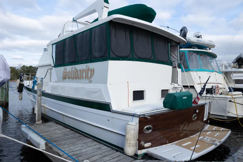 Slide: The Image of 1989 Jefferson Marquessa 52 yacht docked, featuring "Solidarity" name on the stern. - 2