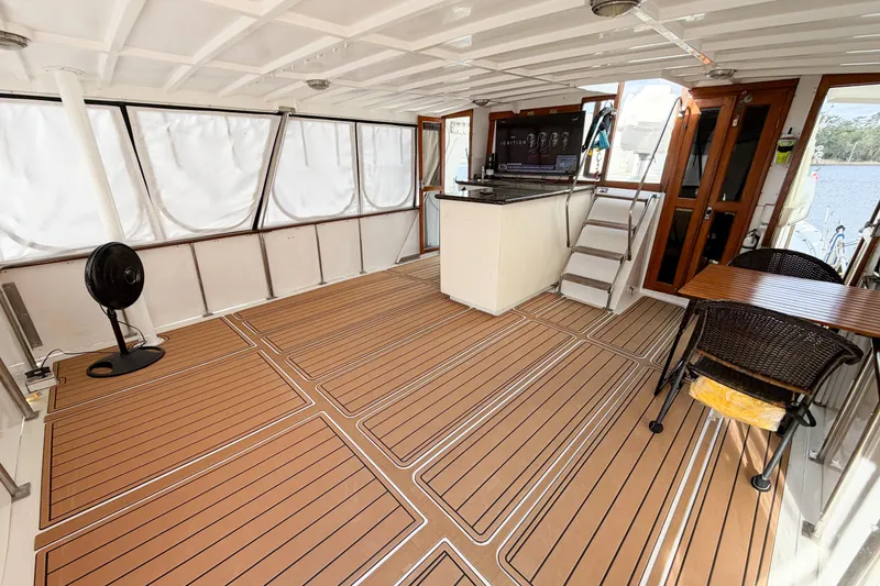 Slide: The Image of Spacious deck of 1989 Jefferson Marquessa 52 yacht with seating and wood flooring. - 20